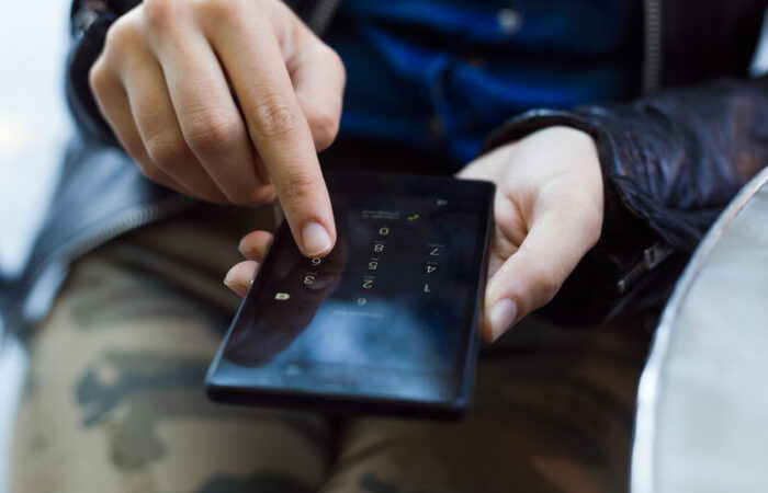 a woman changing her iphone pin number